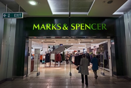 people are walking towards the glass doors.