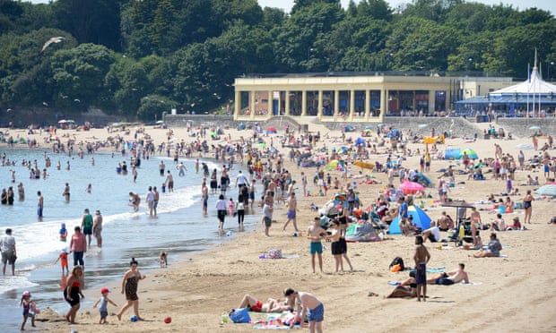 Sunbathers pack the beach at Barry Island, south Wales, on Monday.