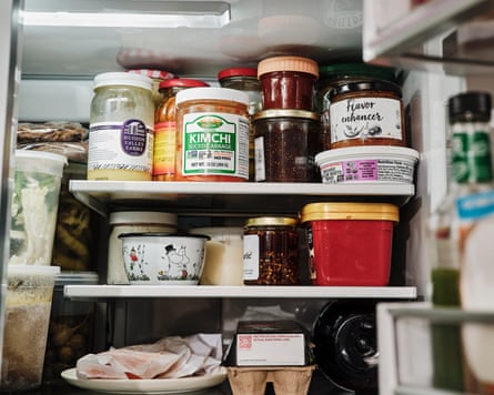 Inside of a fridge, with jars of food, including kimchi.