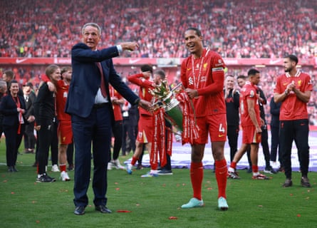 Virgil van Dijk and former player Alan Hansen celebrate with the trophy at Anfield