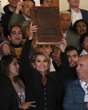 Surrounded by supporters holding up giant Bible.