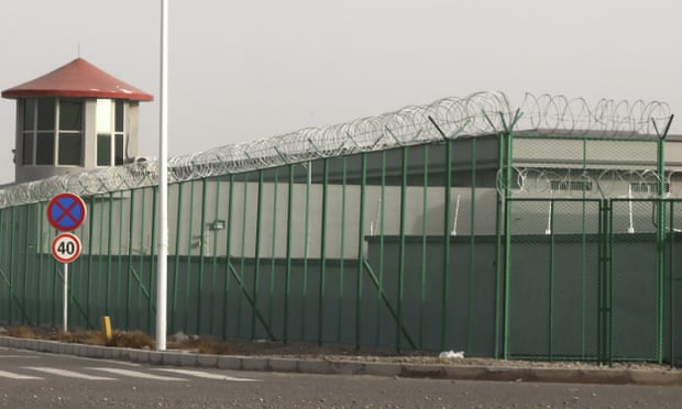 FILE - In this Monday, Dec. 3, 2018, file photo, a guard tower and barbed wire fences surround an internment facility in the Kunshan Industrial Park in Artux in western China’s Xinjiang Uyghur Autonomous Region. A spokesperson for the Xinjiang region called accusations of genocide “totally groundless” as the British parliament approved a motion Thursday, April 22, 2021 that said China’s policies amounted to genocide and crimes against humanity. (AP Photo/Ng Han Guan, File)
