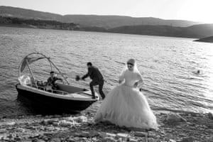 Murat YazarA couple taking a boat tour in Lake Dukan before their wedding celebration