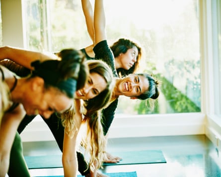Smiling woman laughing with friends during yoga class in studio