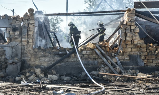 Firefighters at the scene of a Russian missile attack in the village of Dachnoye in Odesa, Ukraine.
