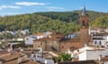 village, church tower and green hills