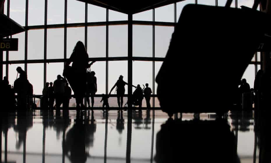 Silhouettes of travellers at a US airport