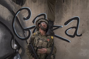 Soldiers climb a wall as they mount an assault on a complex at the facility