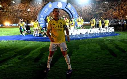 Cristiano Ronaldo stands in the dark in front of his teammates on the podium