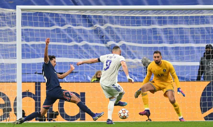 Karim Benzema of Real Madrid scores their team’s first goal past PSG’s Marquinhosn (left) and Gianluigi Donnarumma to get the hosts back into the tie.