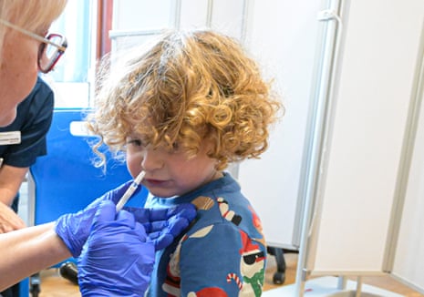 A two-year-old in England receives a nasal flu vaccination.