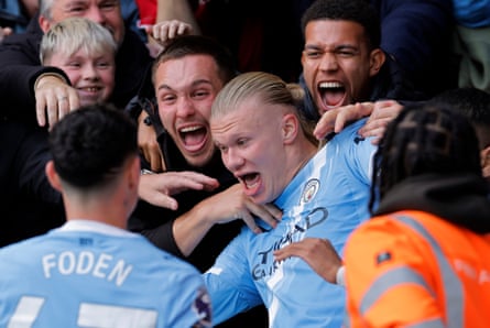 Erling Haaland is pulled into the crowd by jubilant men.