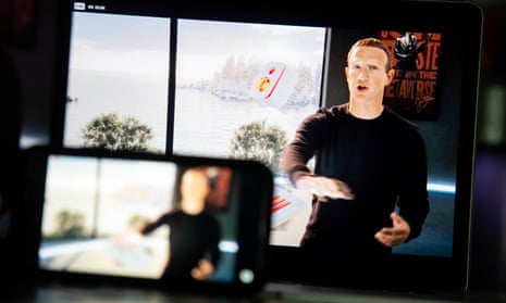 Mark Zuckerberg seen speaking in a livestream on two electronic screens, one big and one small, with the larger screen in the background in sharp focus
