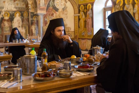 A monk in deep thought as he eats in silence in the refectory of Pantokratoros.