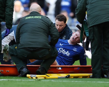Everton’s Jarrad Branthwaite receives medical attention after sustaining an injury during the Merseyside derby