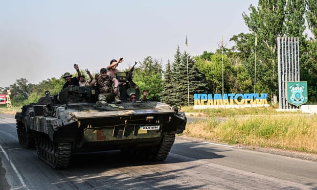 Ukrainian soldiers on the top of a Ukrainian armoured fighting vehicle