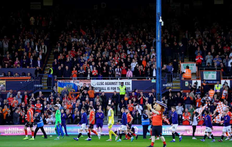 The Luton Town and Huddersfield Town players take to the pitch.