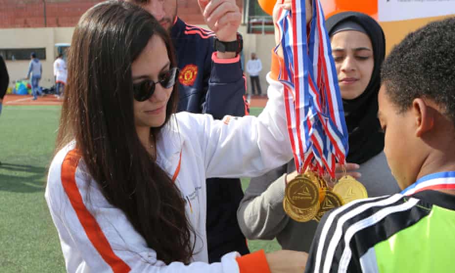Sarah El Jizi, head coach in the Beirut area for Right to Play, hands out football medals at Nahr el-Bared refugee camp in northern Lebanon