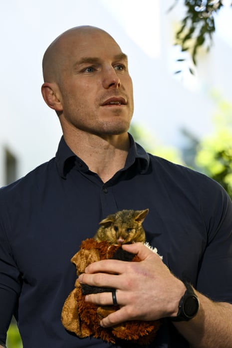 Independent senator David Pocock holds a baby possum as he speaks during a press conference addressing the Samuel review at Parliament House in Canberra, Thursday, 8 December 2022.