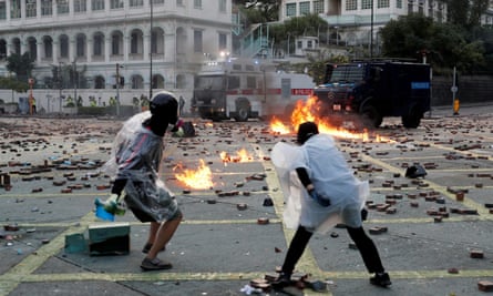 Anti-government protesters in Kong Kong throwing molotov cocktails towards police vehicles during clashes in November