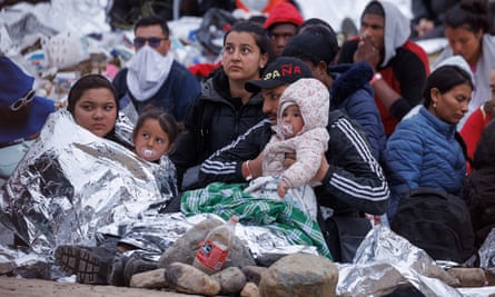 Migrants at the border near San Diego on Thursday.