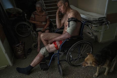 An Ukrainian injured serviceman and an injured civilian wait for medical treatment in Bakhmut, eastern Ukraine.