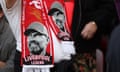 A Liverpool fan wears a Jürgen Klopp scarf in the stands at Anfield