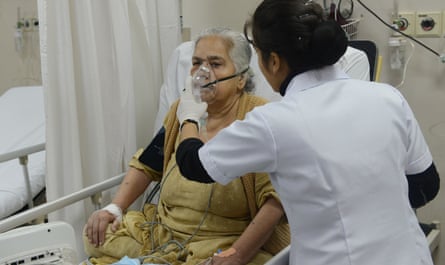 An Indian medic treats a patient at a Delhi hospital during the recent smog crisis.