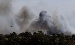 A water-bombing helicopter fights the bushfire at Richmond Vale near Cessnock in the Hunter Valley on Wednesday.