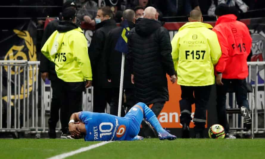 Dimitri Payet of Marseille hits a water bottle thrown by a Lyon fan.