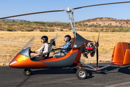 Paul, left, receives instructions on flying a gyrocopter from Britta Penca, right.
