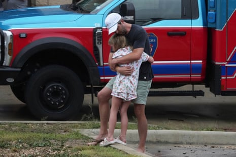 People are reunited at a reunification centre in Ingram, Texas.