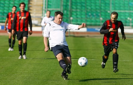 Ed Balls playing football.