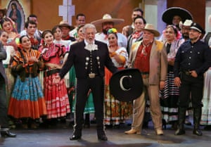 Placido Domingo on stage, with other performers behind him