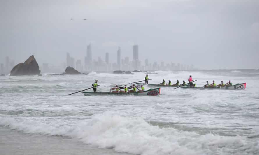 Surf boats perform a burial at sea at the dawn service at Currumbin, during Anzac Day in Gold Coast, Monday, April 25, 2022.