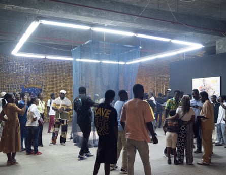 Attenders gather during the opening night of Serge Attukwei Clottey’s exhibition at Gallery 1957 in Accra, Ghana.