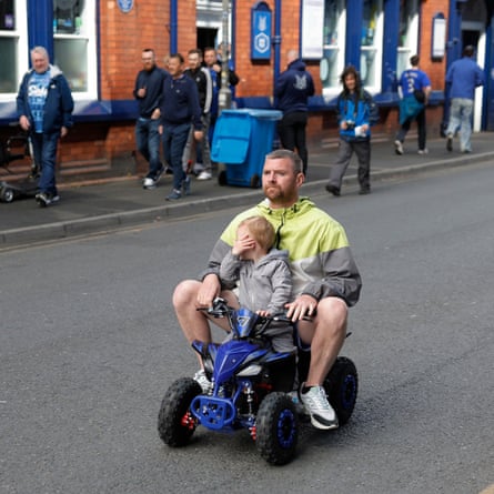 A man and child on a go kart on Goodison Road.