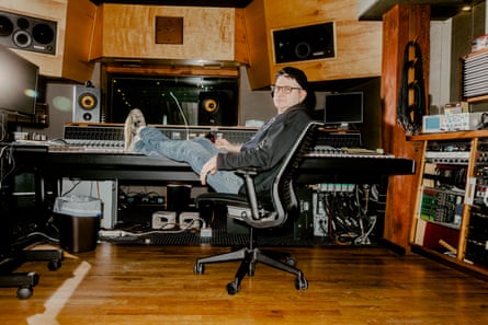 Steve Albini on a chair in his studio, Electrical Audio in Chicago, feet up on the recording table, looking over his shoulder