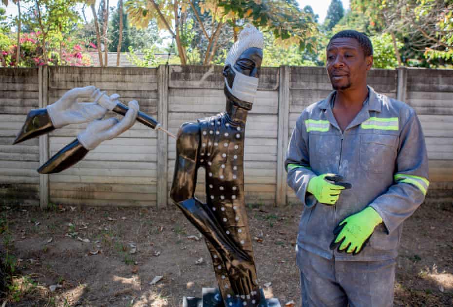 David Ngwerume shows his Covid-inspired sculpture called "Arms" in Harare, Zimbabwe.