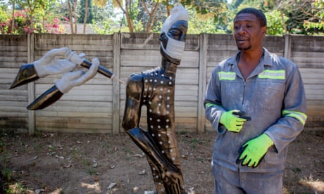 David Ngwerume shows his Covid-inspired sculpture called "Arms" in Harare, Zimbabwe.