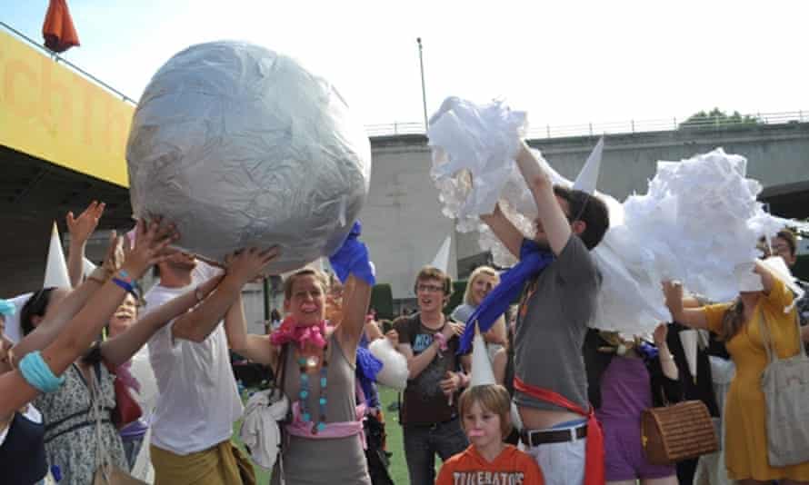Residents play Pass the Impossibly Large Parcel on the South Bank, London in 2010.