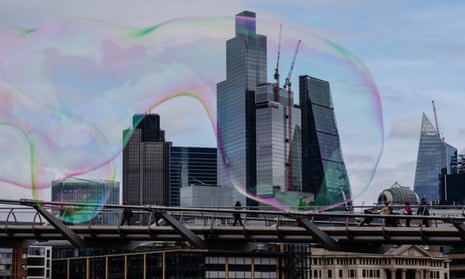 Bubbles float past office buildings in the City of London
