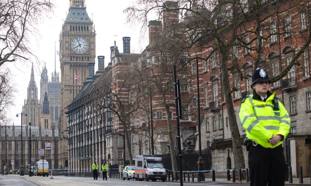 Police officers stand guard on Victoria Embankment in London