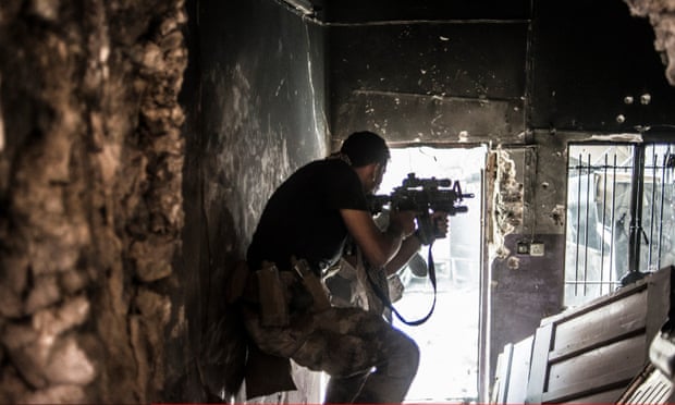 An Iraqi soldier fires at an Isis militant in Mosul, Iraq. 