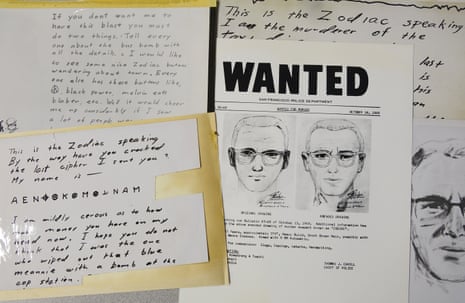Displayed are copies of handwritten letters from the Zodiac killer which included one of his signature ciphers. Next to it is a wanted poster which contained a hand drawn likeness.