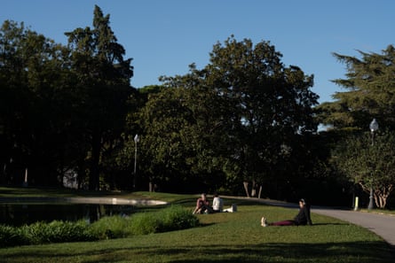 People lie on the lawns of Montjuïc Gardens.
