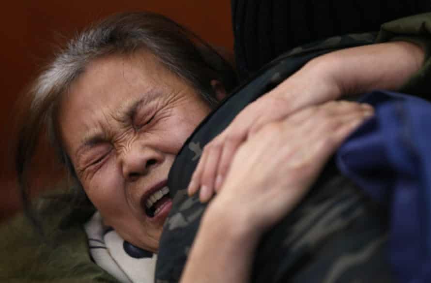 A woman whose daughter was on board MH370 cries before a meeting with Malaysian Airlines officials in Beijing