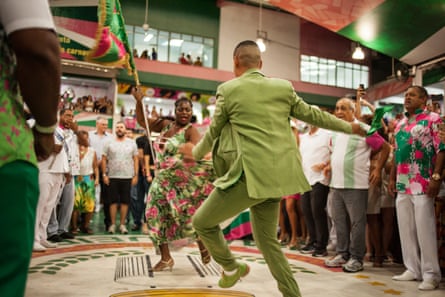 The Mangueira samba school flag-bearer and her escort perform during a rehearsal show.