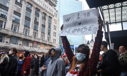 People take part in a protest over the death of George Floyd in central Auckland, New Zealand.