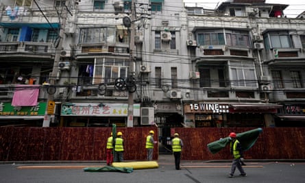 Workers set up barriers before the second stage of a two-stage lockdown in Shanghai.